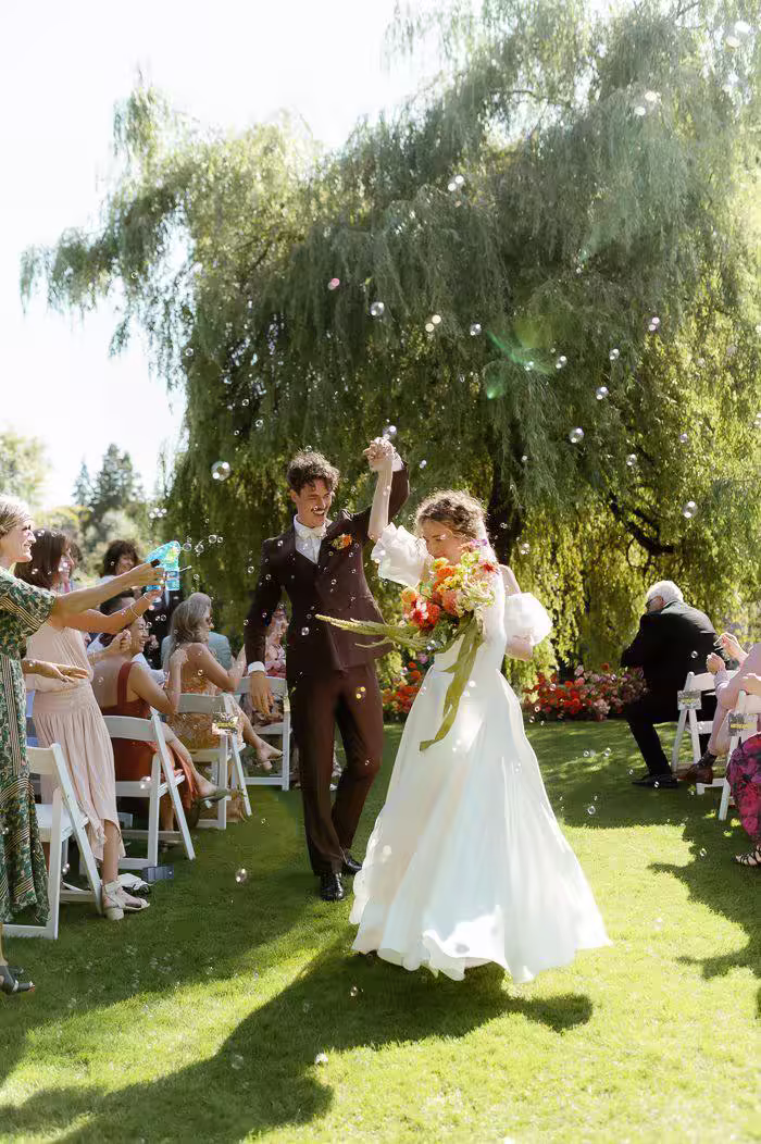 Wedding ceremony with guests capturing the moment on their phones